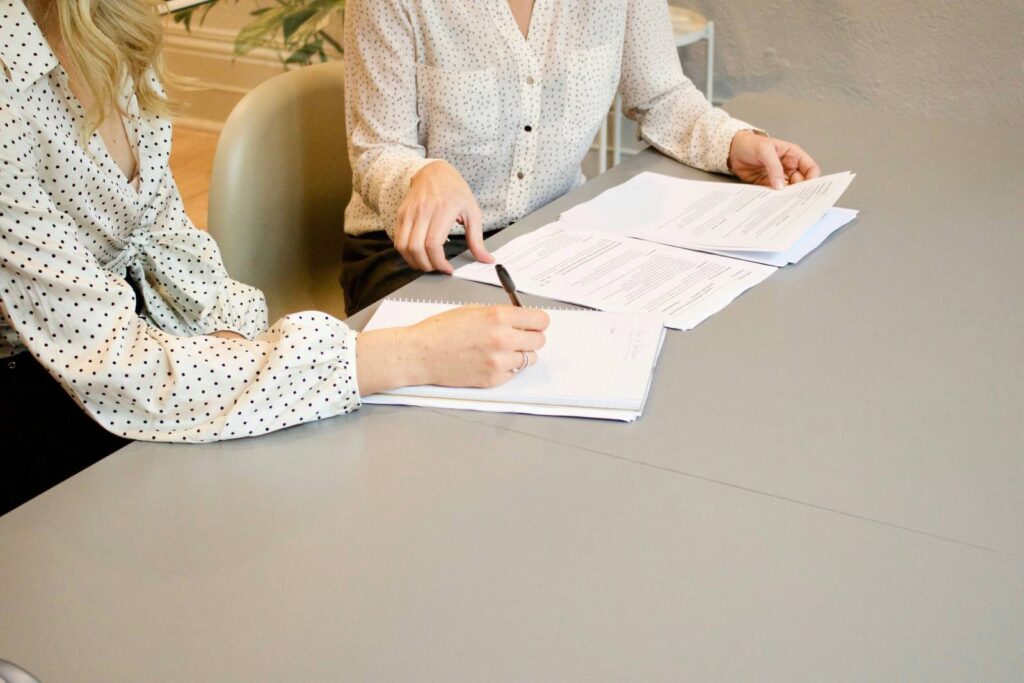 woman in suite signing contract